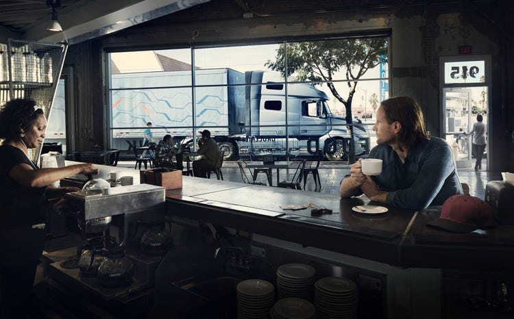 Volvo Truck passing by a coffee shop
