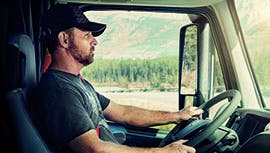 a man in a truck wearing a seatbelt