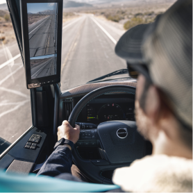 Driver's view inside a Volvo VNL, highlighting smart mirror display.