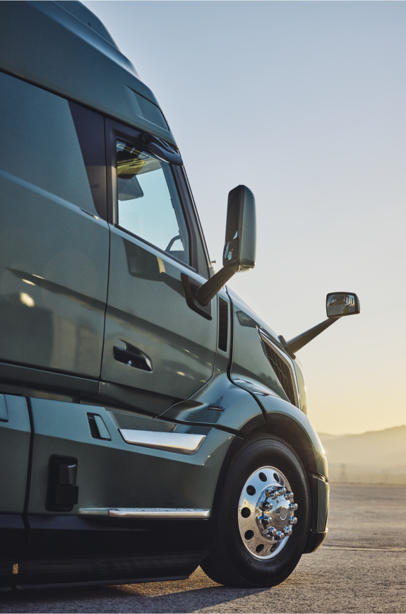 Side view of Volvo VNL truck with aerodynamic design at sunrise.