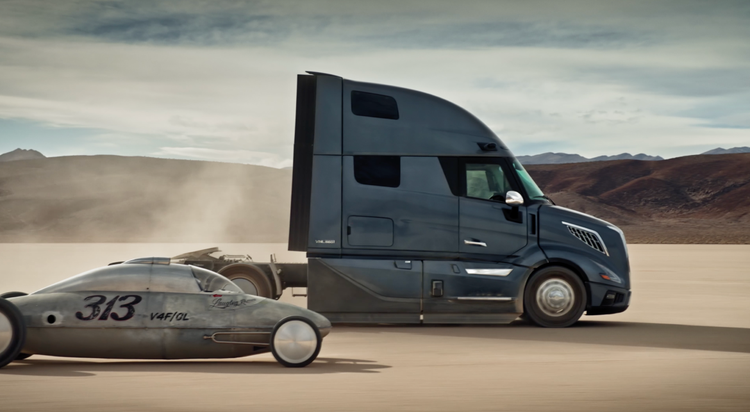 Side view of a Volvo VNL truck showcasing aerodynamics on a dry lakebed.