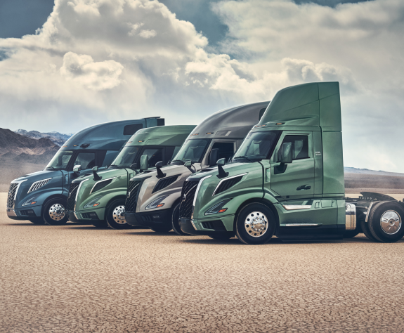 Lineup of Volvo VNL trucks showcasing various models and colours like Coastal Mist, Prairie Grasslands, Desert Mirage and Skyline Steel