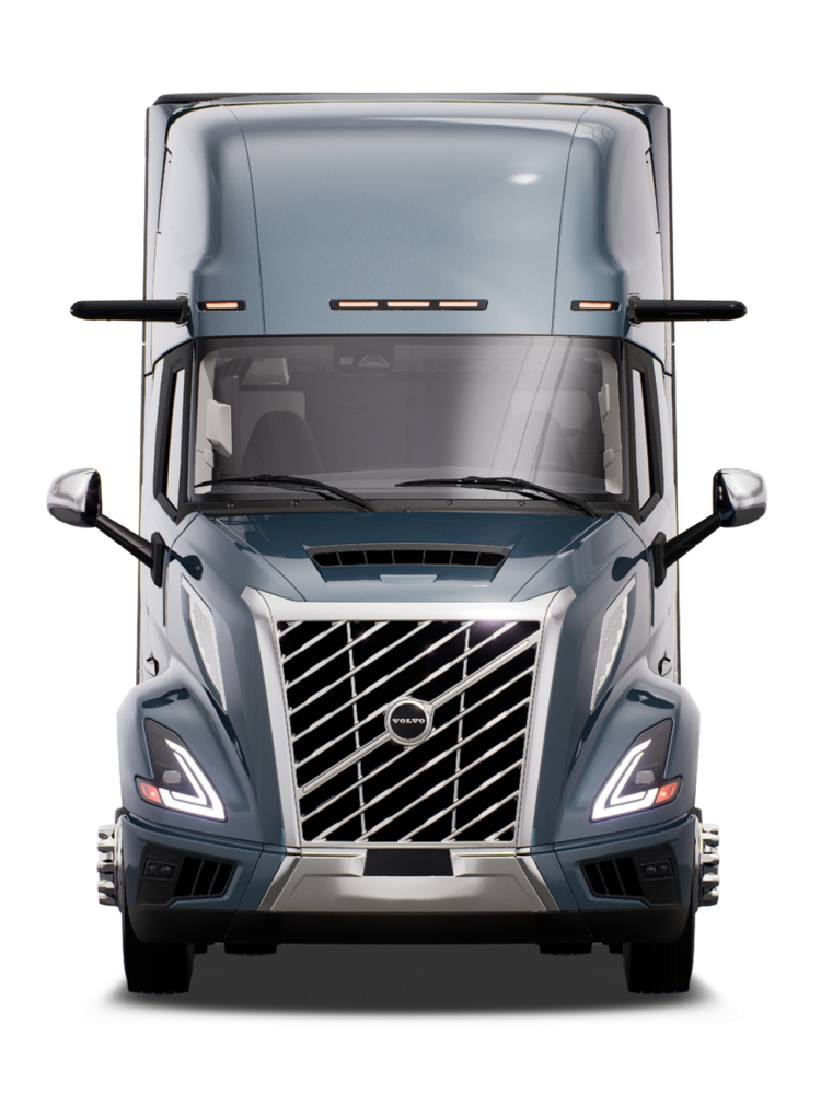 Front view of a Volvo all new VNL semi truck with a Coastal Mist exterior, showcasing its distinctive grille design, headlights, and side mirrors.