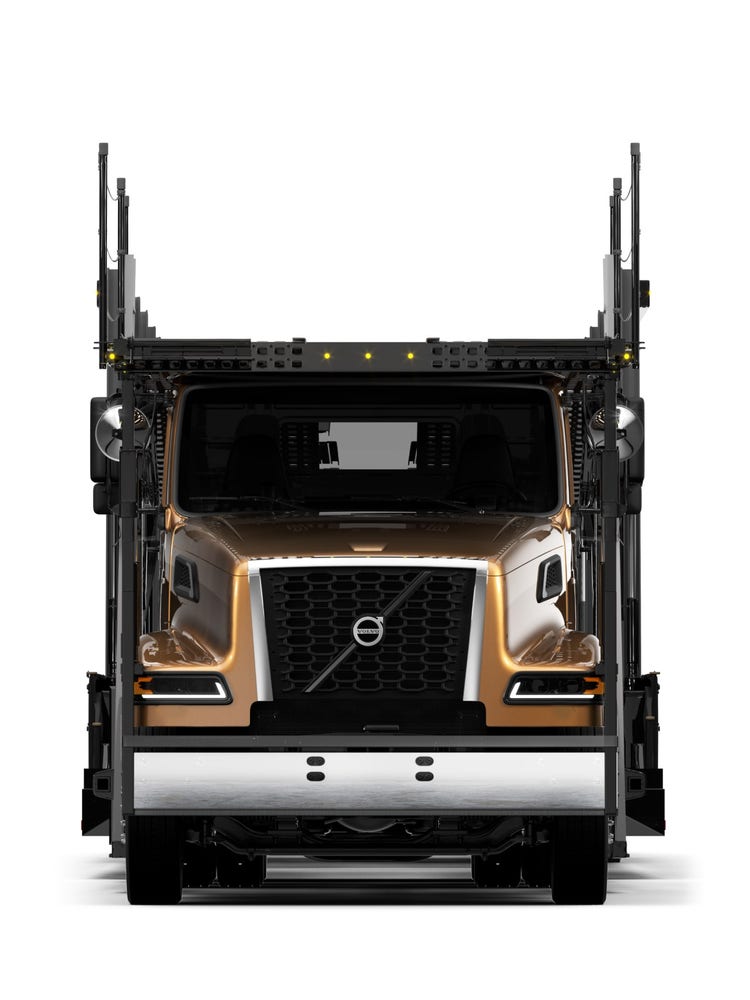 Head-on view of a Premium School Bus Yellow Volvo VAH truck, a big tuck, showcasing its structure for efficient vehicle transport