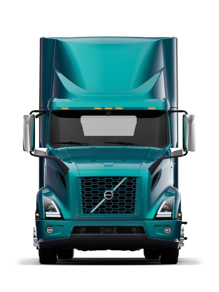Front view of a Volvo VNR Electric semi truck with a teal exterior, known for its zero-emission electric powertrain.