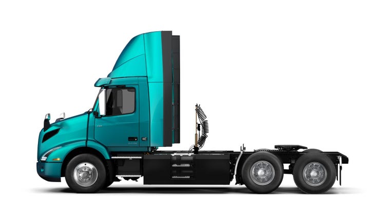 A teal Volvo VNR Electric semi truck seen in profile, highlighting its clean energy electric powertrain.