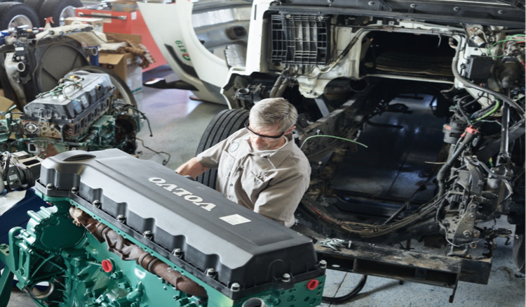 Service Technician Working on Volvo Trucks Engine