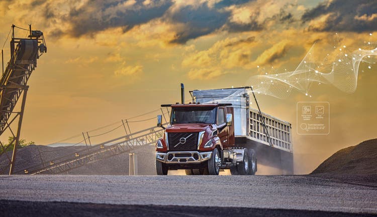 A red color Volvo VNX on a construction site.