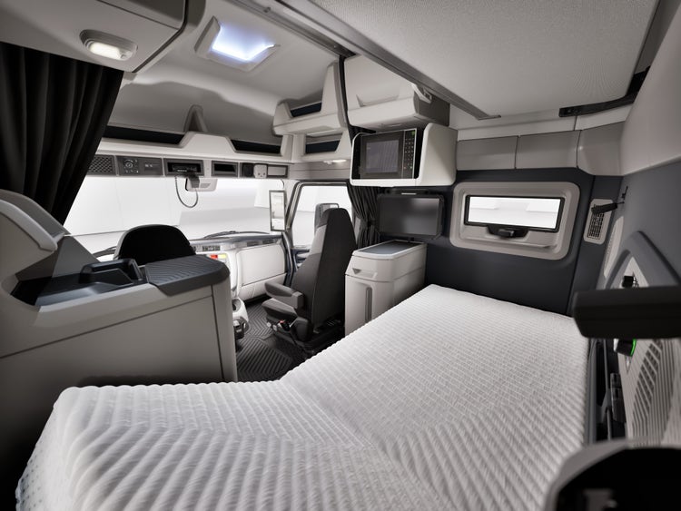 An inside view of the Volvo VNX that shows the comfortable space where drivers can sleep after a long drive. The Standard footwell lighting helps illuminate the sleeper when moving through the cab at night.