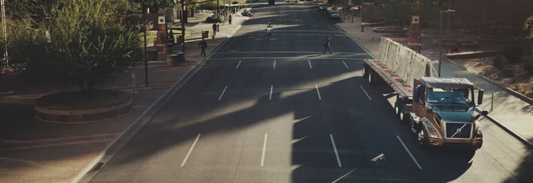 A Volvo truck driving on the road.