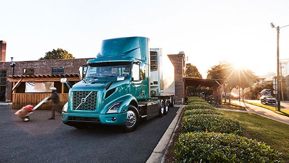 The Volvo VNR Electric truck parked in an urban setting.