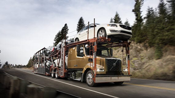 A Volvo VAH truck carrying multiple vehicles.