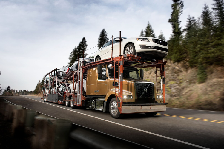 A Volvo VAH truck carrying multiple vehicles.