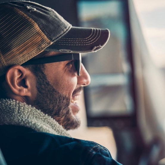 Truck driver wearing a cap and sunglasses