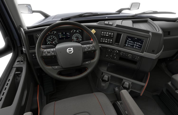 Driver's view of the Volvo VNR cab interior, showcasing the steering wheel with integrated controls, digital dashboard, and infotainment system.