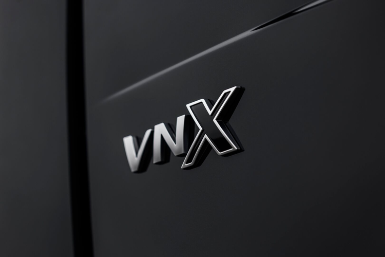 Close-up of the VNX badge on the side of a black Volvo VNX truck