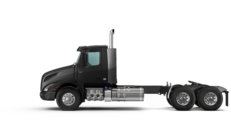 Side view of a black Volvo VNX truck, showcasing its durable chassis, polished fuel tanks, and aerodynamic cab design for heavy-duty hauling.