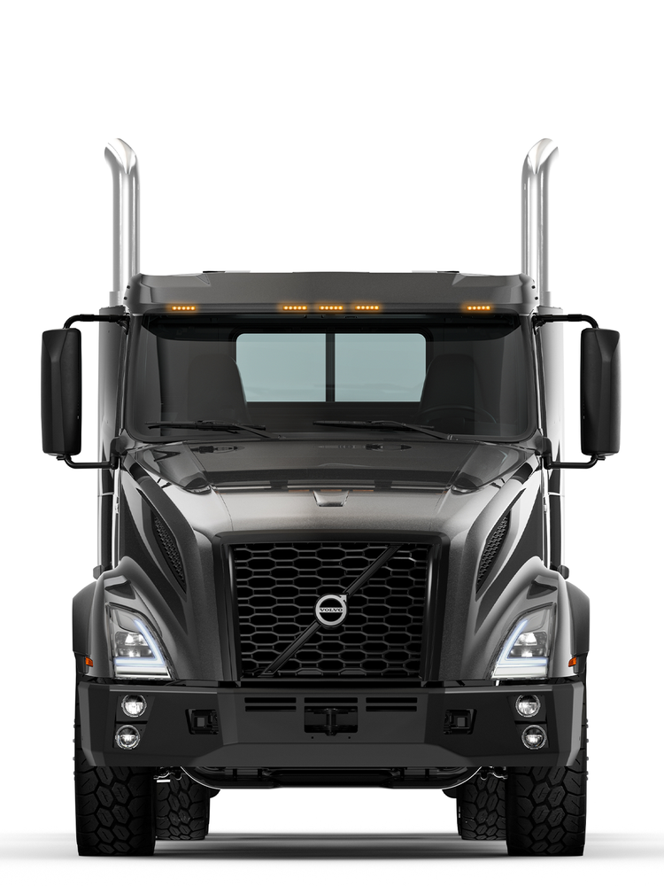 Front view of a black Volvo VNX truck, featuring a bold grille, LED headlights, and chrome exhaust stacks, designed for heavy-duty performance and durability.